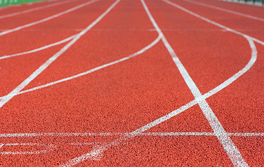 Image showing Red treadmill at the stadium with white lines 