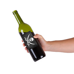 Image showing Hand holding a bottle of red wine