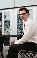 Image showing Businessman sitting outside at a table