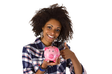 Image showing Young african american woman with piggy bank