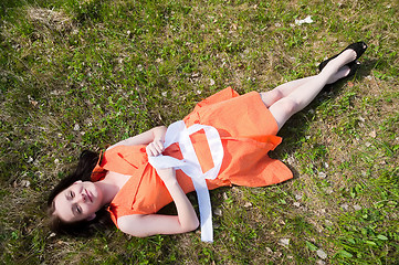 Image showing Pretty girl laying on grass