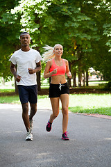 Image showing young couple runner jogger in park outdoor summer