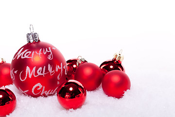 Image showing christmas decoration festive red bauble in snow isolated