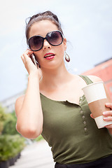 Image showing attractive young woman with smartphone and sunglasses outdoor