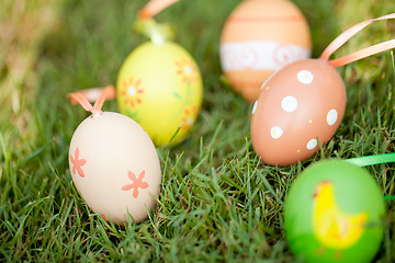 Image showing colored easter eggs group in green grass outdoor in spring