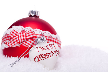 Image showing christmas decoration festive red bauble in snow isolated