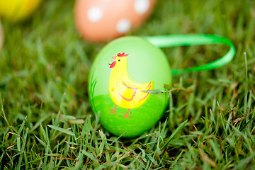 Image showing colored easter eggs group in green grass outdoor in spring