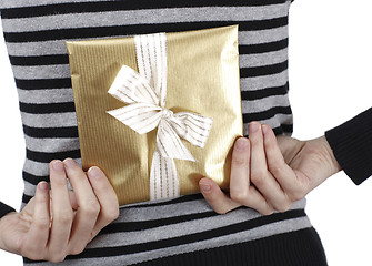 Image showing Young woman holding a present