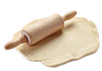 Image showing Wooden rolling pin and dough