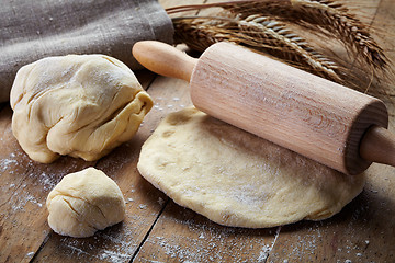 Image showing fresh dough and rolling pin