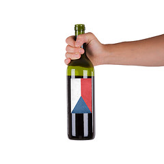 Image showing Hand holding a bottle of red wine