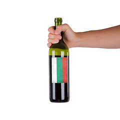 Image showing Hand holding a bottle of red wine