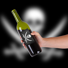 Image showing Hand holding a bottle of red wine