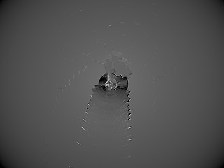 Image showing Glass with shattered part in the center: bullet hole