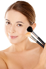 Image showing Beautiful woman holding two cosmetic brushes