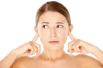 Image showing Woman blocking her ears with her fingers