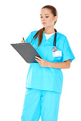 Image showing Pretty young nurse writing up notes