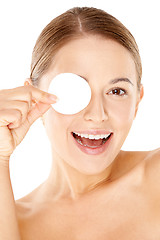 Image showing Laughing woman holding a cotton pad to her eye