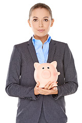 Image showing Businesswoman holding a piggy bank