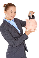 Image showing Successful businesswoman with a piggy bank