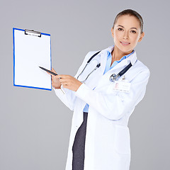 Image showing Female doctor displaying a blank clipboard