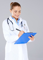 Image showing Doctor writing on a patients file