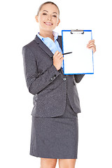 Image showing Friendly businesswoman pointing to a clipboard