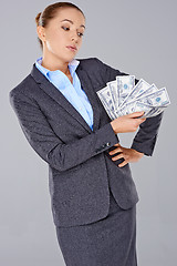 Image showing Successful businesswoman with a wad of money