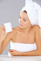 Image showing Woman at a spa looking at a mug of coffee