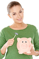 Image showing Woman contemplating opening her piggy bank