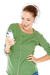 Image showing Woman laughing as she enjoys her music