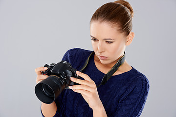 Image showing Female photographer checking an image