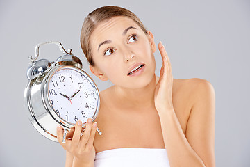 Image showing Woman holding an alarm clock