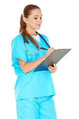 Image showing Pretty young nurse writing up notes