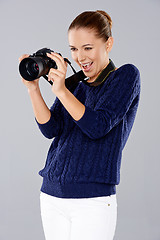 Image showing Female photographer assessing her shot