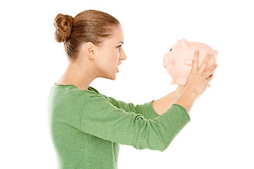 Image showing Angry woman arguing with her piggy bank