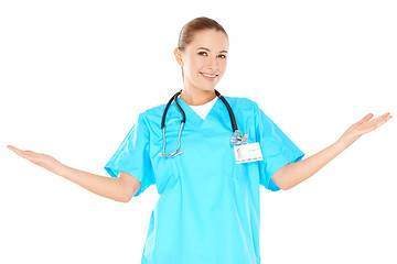 Image showing Smiling woman doctor raising her hands