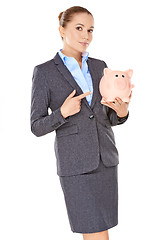 Image showing Businesswoman holding a piggy bank