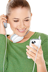 Image showing Woman listening to a new music download