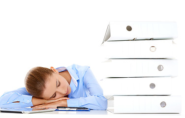 Image showing Tired businesswoman asleep at her desk