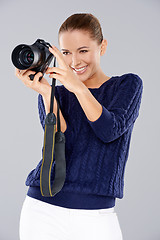 Image showing Happy woman holding a professional camera