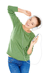 Image showing Blissful woman dancing and listening to music