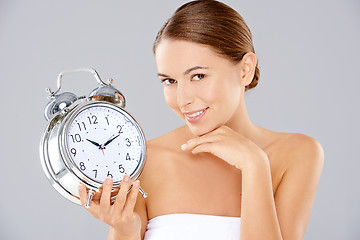 Image showing Woman holding an alarm clock