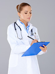 Image showing Doctor writing on a patients file