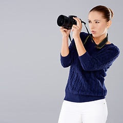 Image showing Female photographer assessing her shot