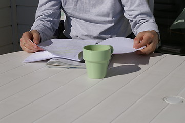 Image showing Table with cup and papers