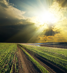 Image showing sun and clouds over road