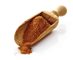 Image showing wooden scoop with cinnamon powder