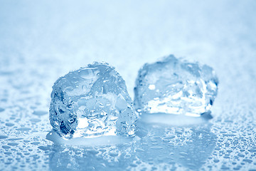 Image showing ice cubes on a wet light blue background