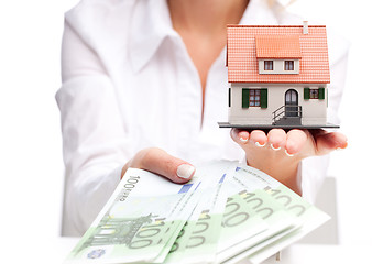 Image showing Little house toy and money in woman's hands